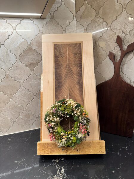 Mini wreath displayed on a wooden stand