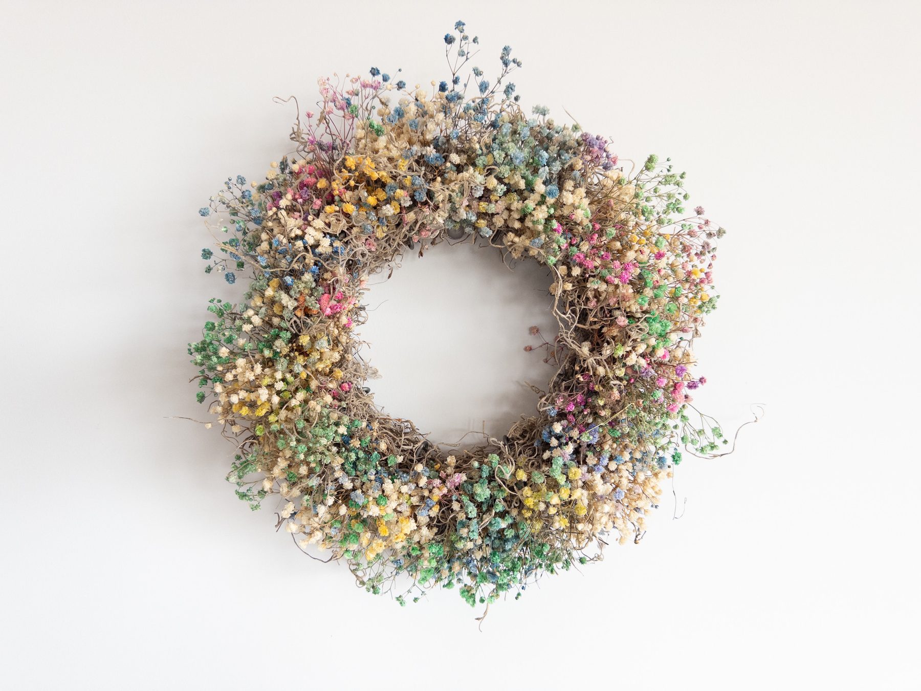 Colorful preserved wildflower wreath by STIX&STONES CO.